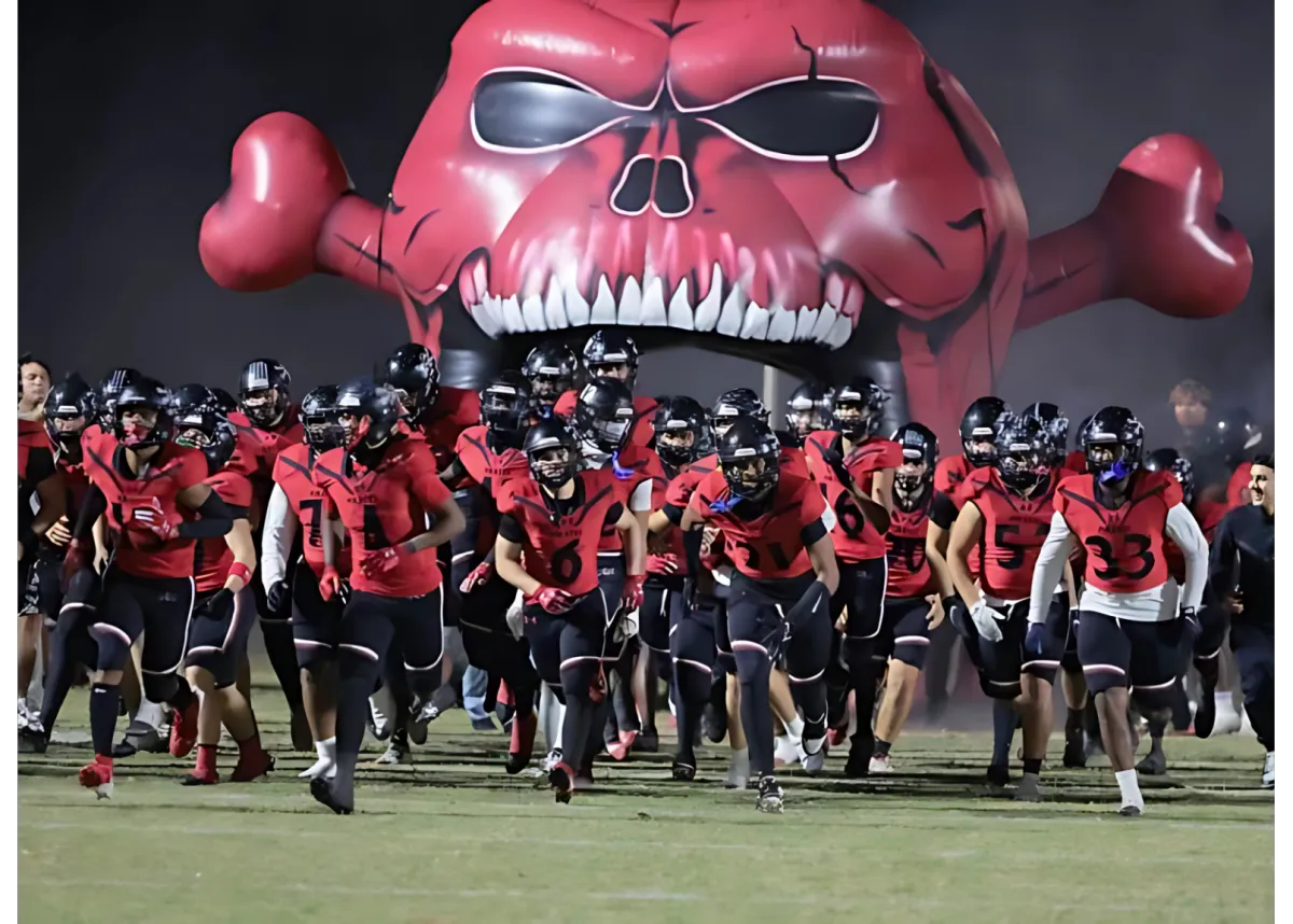 Port Charlotte Pirate football players on the field under stadium lights